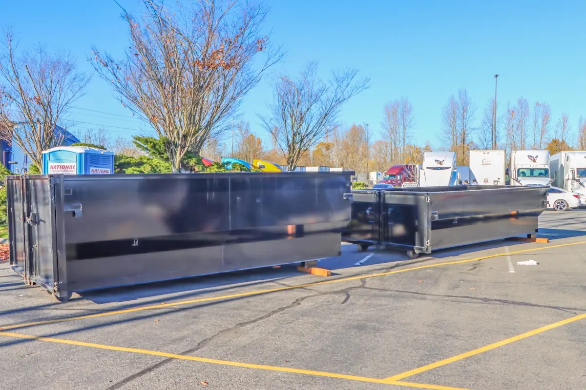 Professional dumpster rental service with roll-off container on residential driveway in Holly Ridge